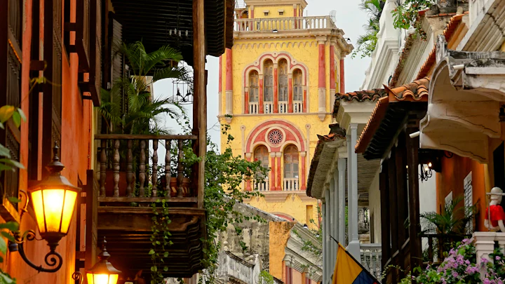 A colonial street and yellow church tower in Cartagena, Colombia