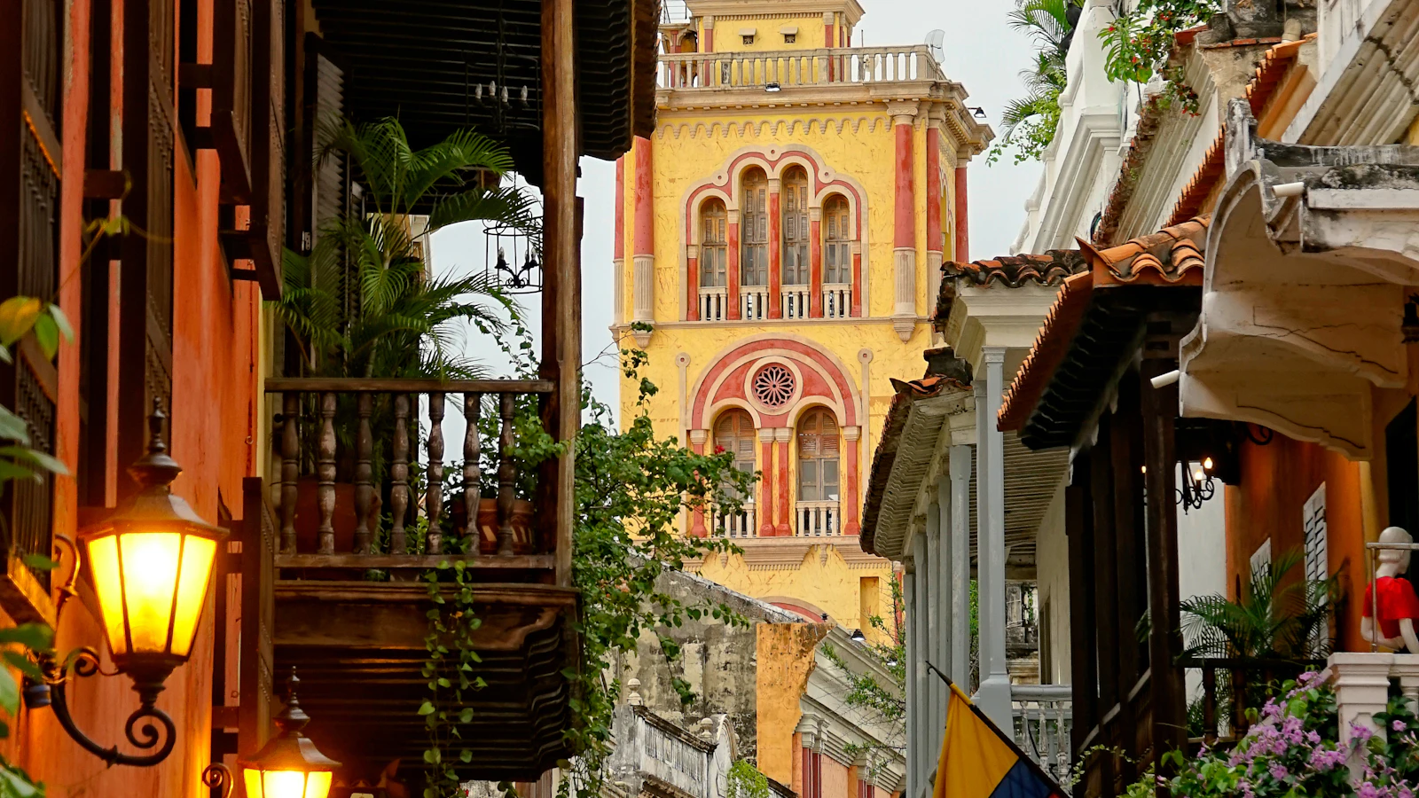A colonial street and yellow church tower in Cartagena, Colombia